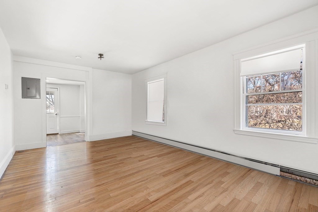 29 Harding Avenue Everett, MA 02149 - Photo 3 of 32 an empty room with wooden floor and windows