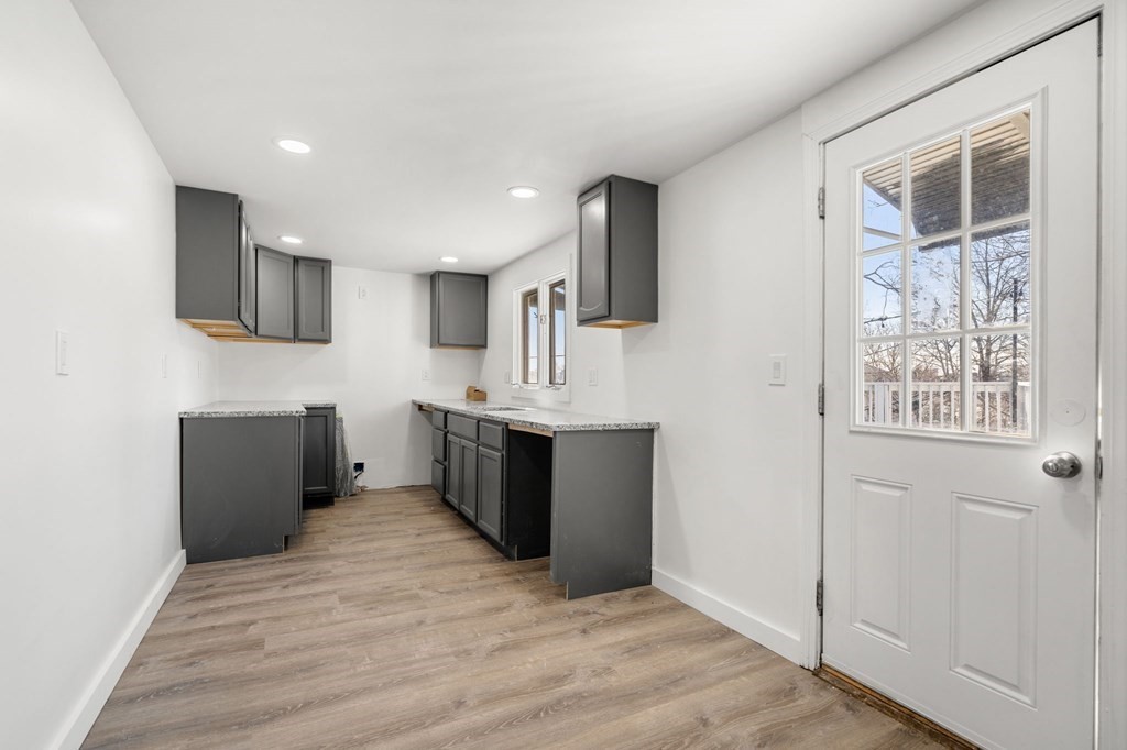 29 Harding Avenue Everett, MA 02149 - Photo 5 of 32 a large white kitchen with a sink a microwave and refrigerator