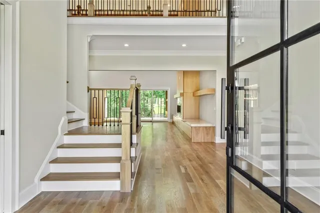 a kitchen with kitchen island a stove a sink and white cabinets