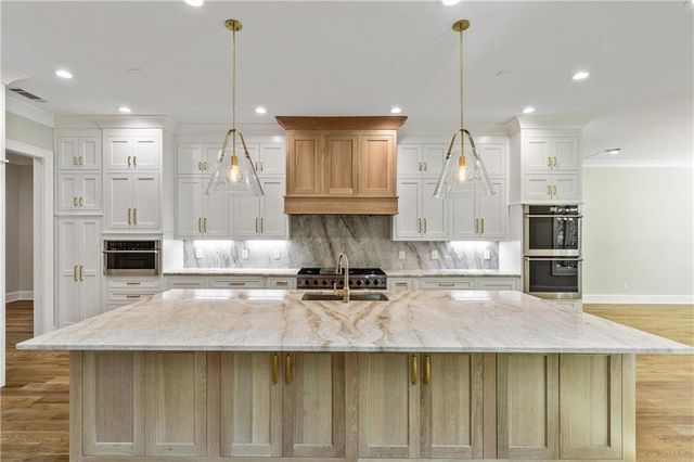 a bathroom with a granite countertop toilet sink and mirror