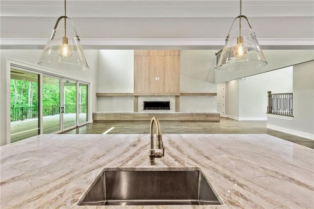 a bathroom with a granite countertop sink mirror and window