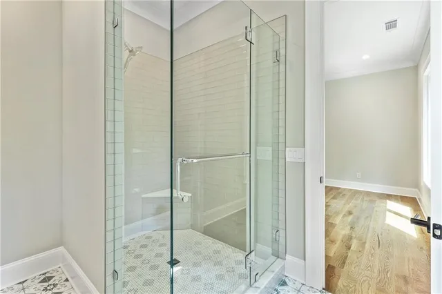 a bathroom with a granite countertop sink a mirror and a shower