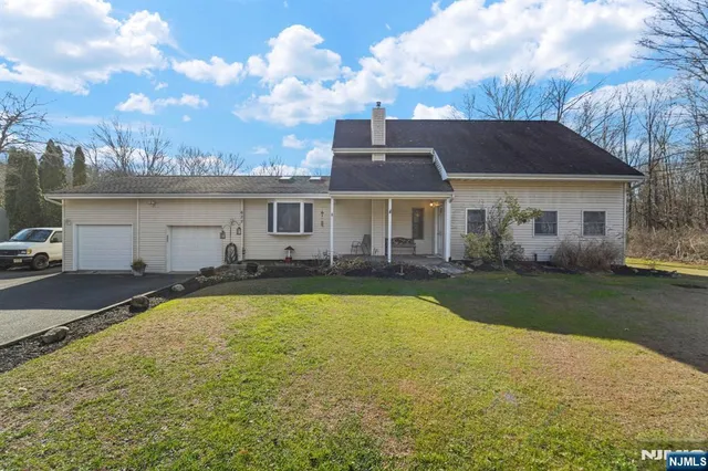 a view of a house with swimming pool and a yard