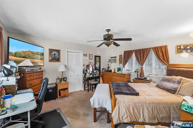 a bedroom with furniture and a large window