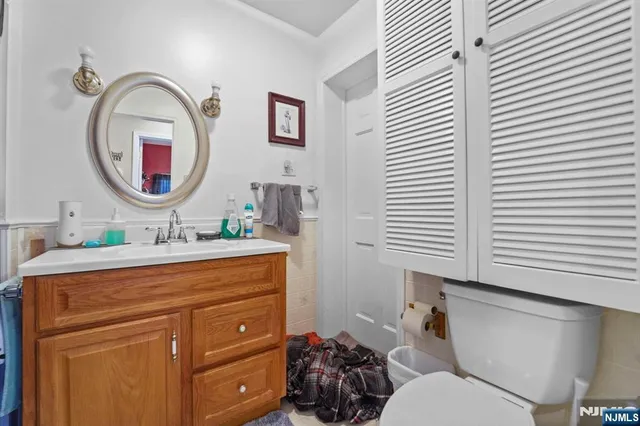 a bathroom with a toilet a sink and a mirror