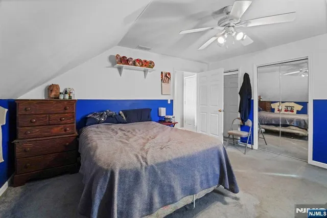 a bed room with a bed and a chandelier