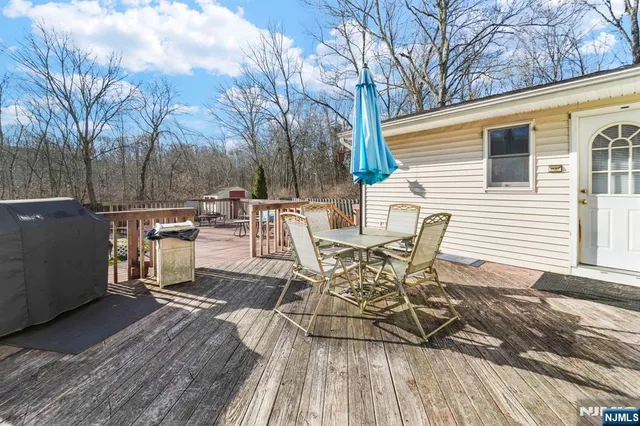 a view of a patio with table and chairs and wooden floor