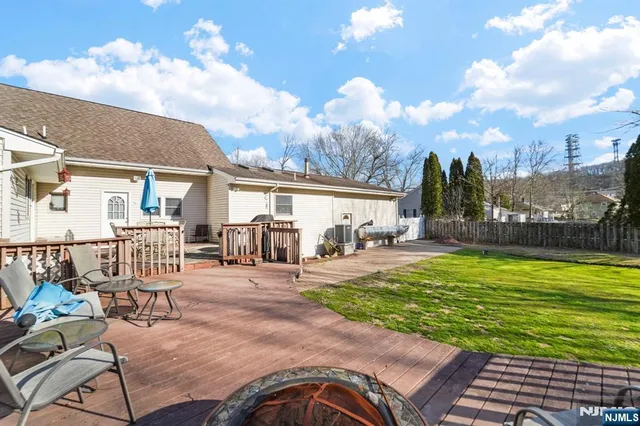a view of a house with backyard porch and sitting area