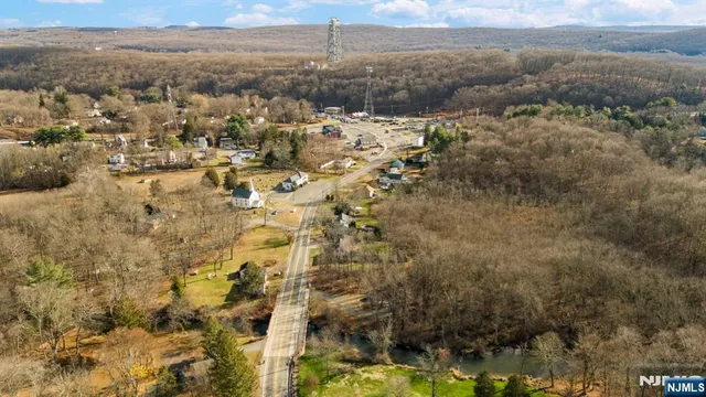 a view of a house with a mountain and a forest