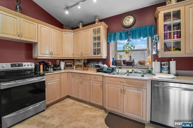 a kitchen with stainless steel appliances granite countertop a stove and cabinets