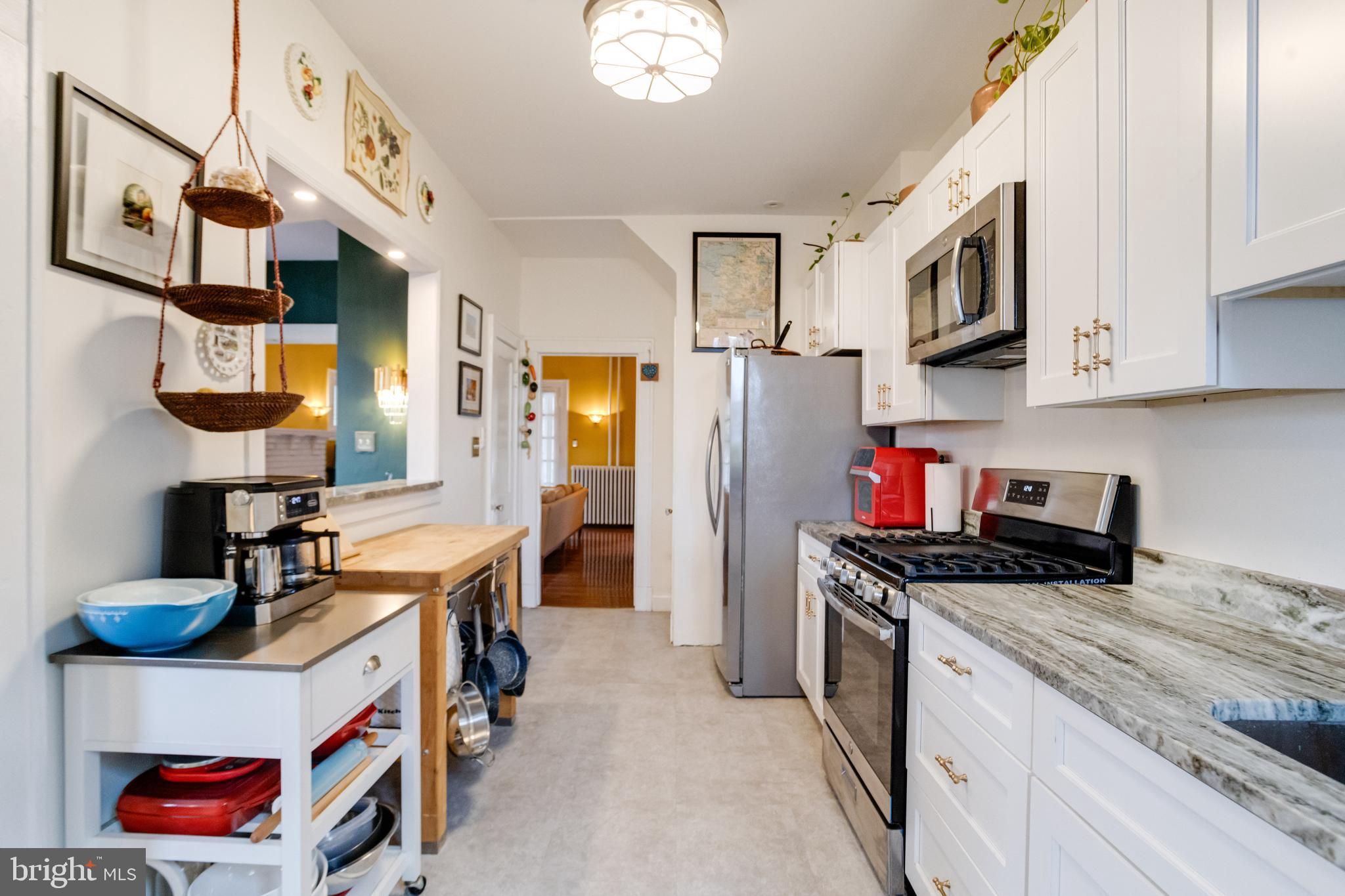 3901 Keswick Road Baltimore, MD 21211 - Photo 31 of 87 a kitchen with stainless steel appliances granite countertop a sink stove and cabinets