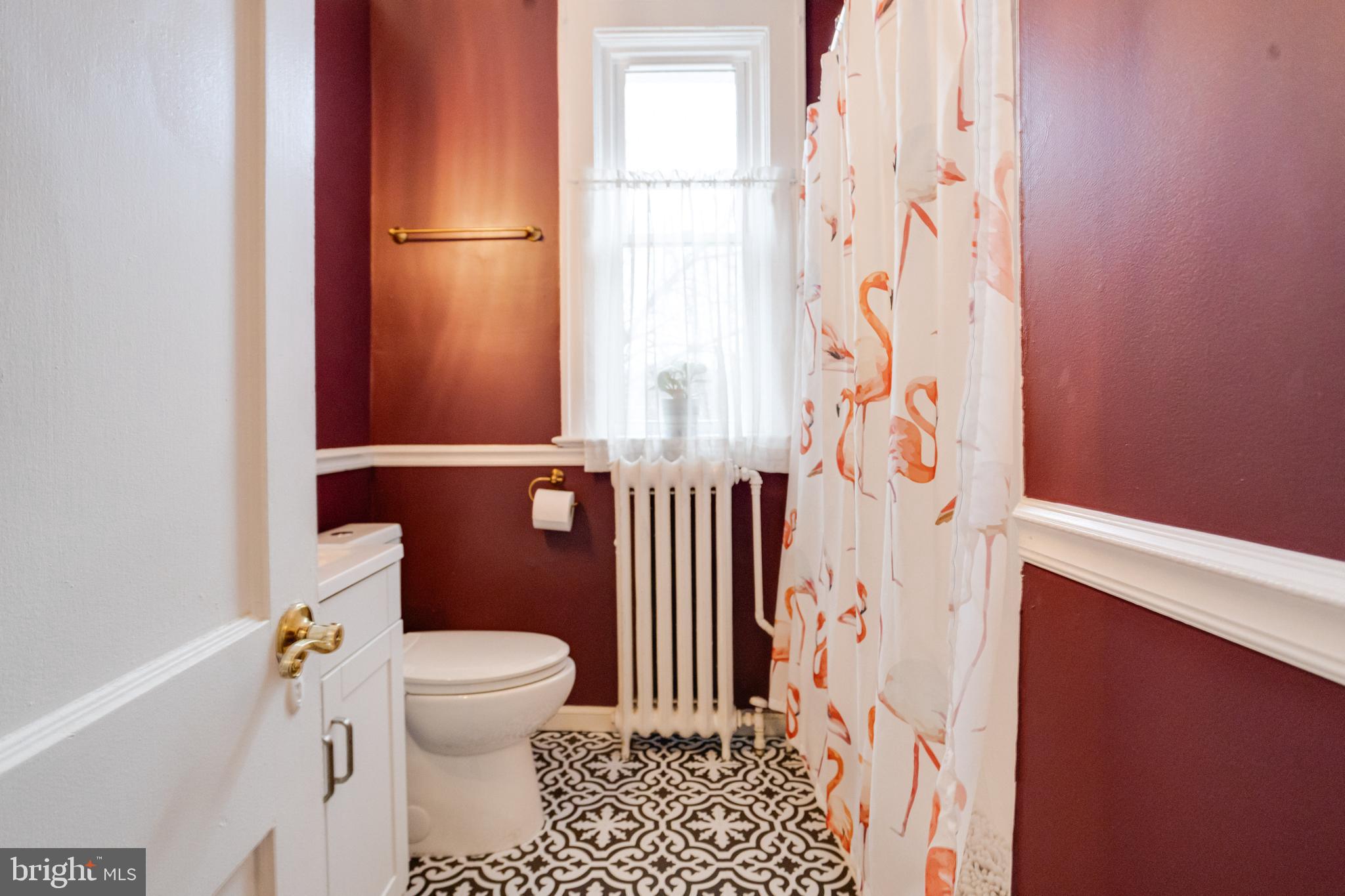3901 Keswick Road Baltimore, MD 21211 - Photo 40 of 87 a bathroom with a toilet and a shower curtain