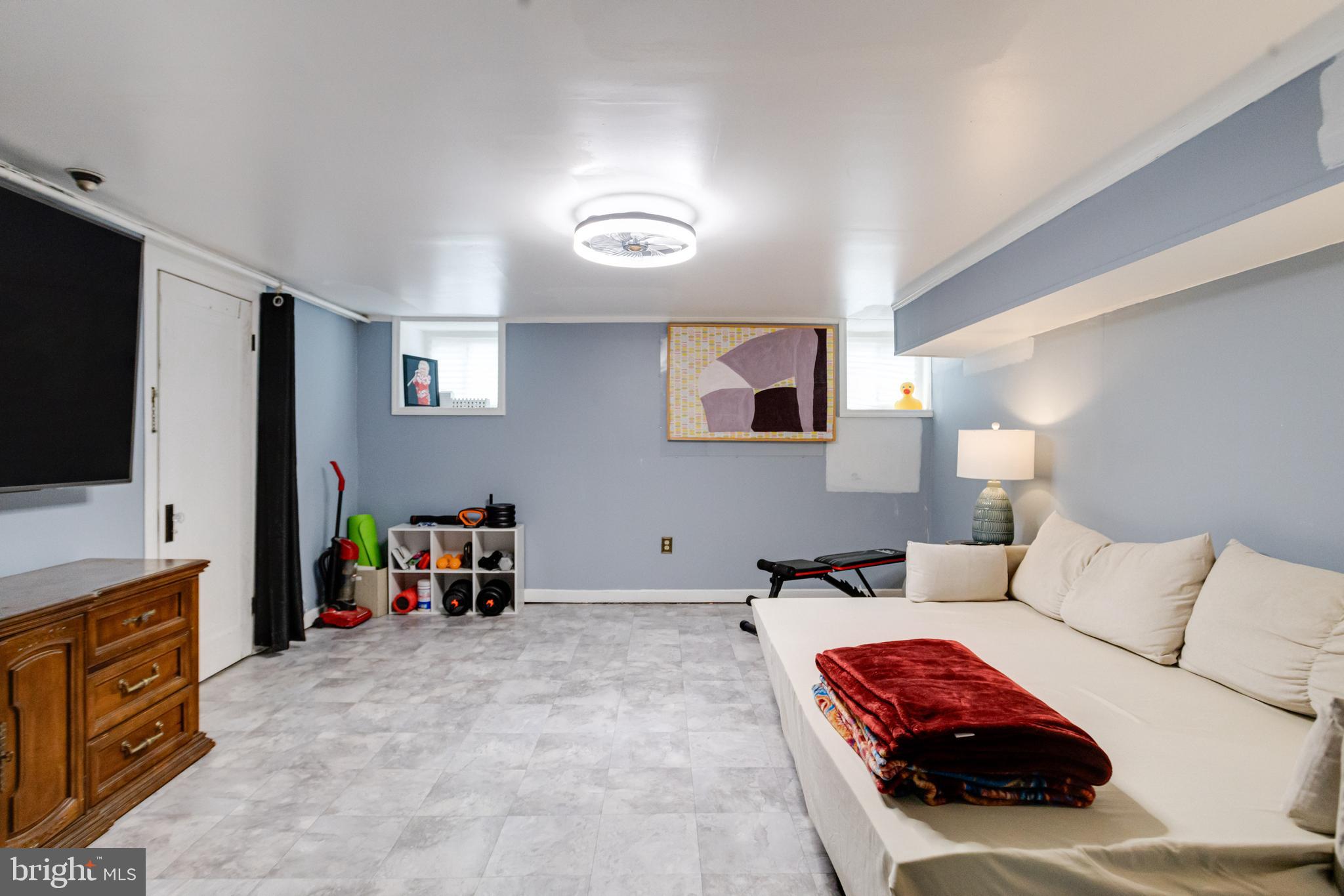 3901 Keswick Road Baltimore, MD 21211 - Photo 67 of 87 a bedroom with a bed and a flat tv screen on the dresser