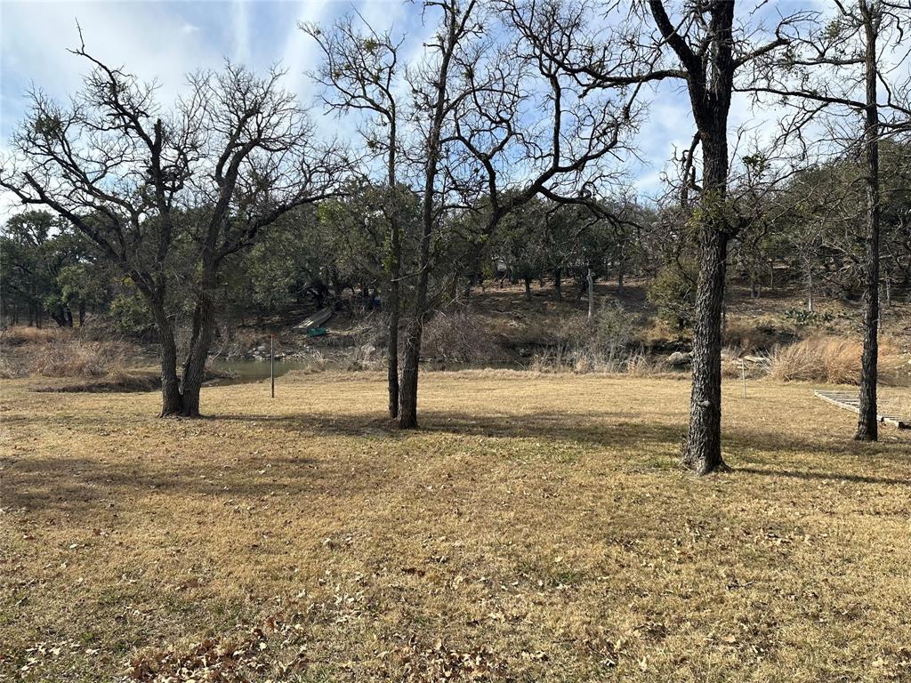 Lot 632 Lakeside Drive May, TX 76857 - Photo 6 of 9 a view of dirt yard with a tree