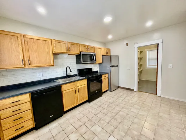 a kitchen with a sink cabinets and appliances