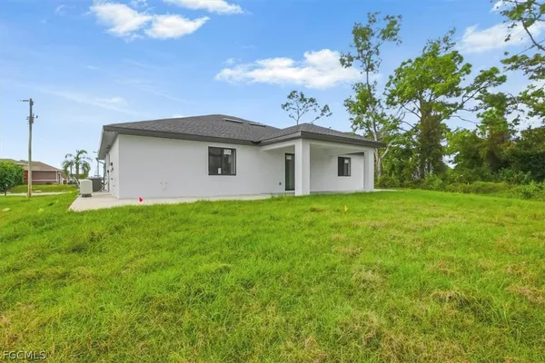 a front view of house with yard and green space