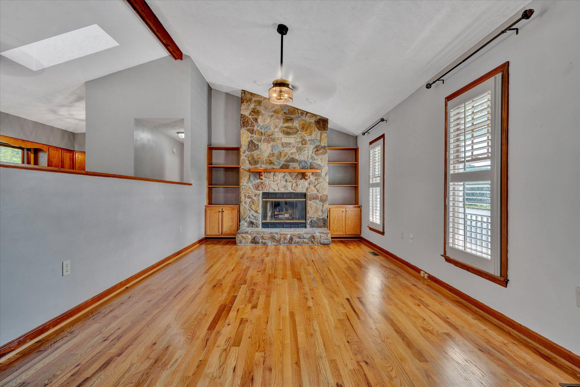 3700 Rte 3004 Roanoke, VA 24012 - Photo 8 of 40 a view of an empty room with wooden floor fireplace and a window