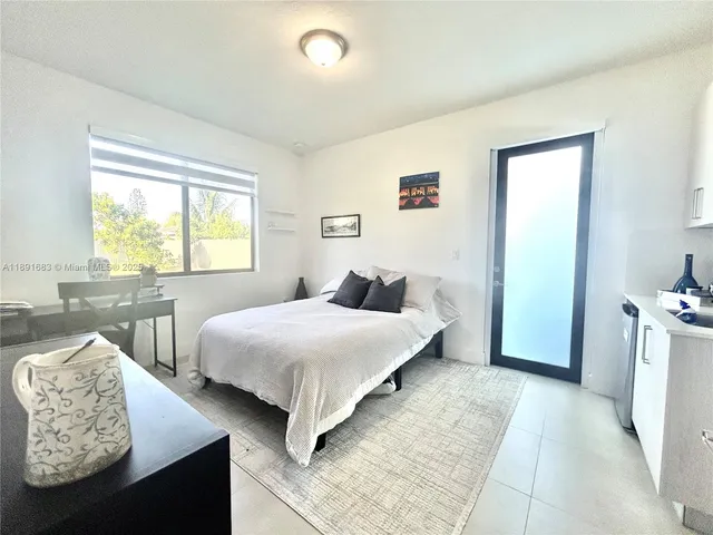 a bedroom with a bed and a chair