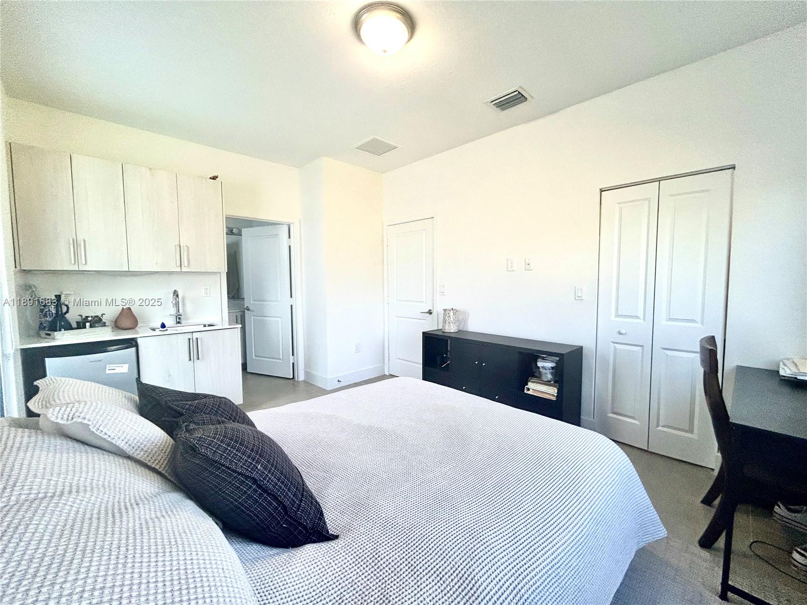 13281 Southwest 227th Street, Unit 1 Miami, FL 33170 - Photo 4 of 8 a bedroom with a bed and a chair