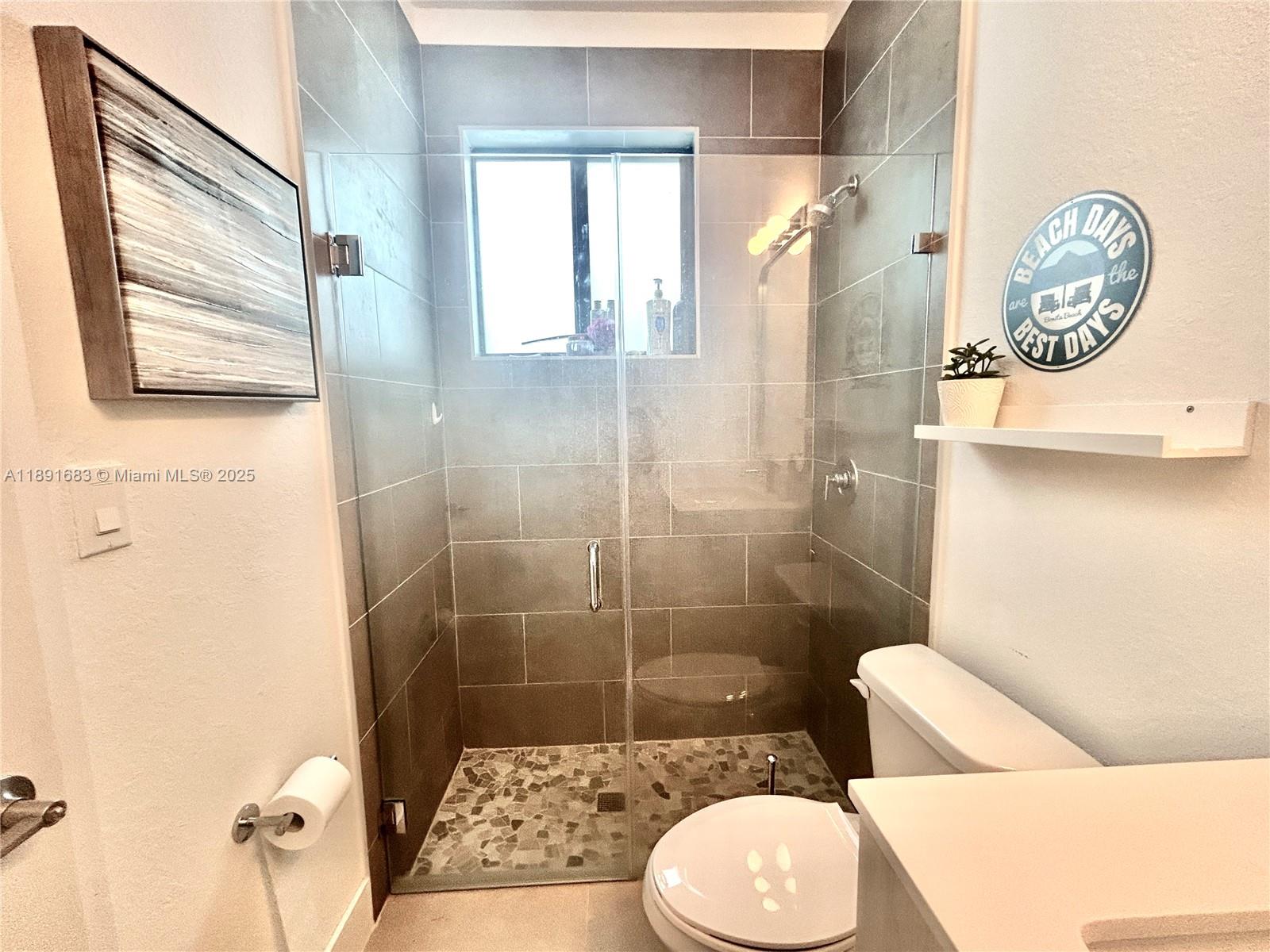 13281 Southwest 227th Street, Unit 1 Miami, FL 33170 - Photo 7 of 8 a bathroom with a toilet and a shower