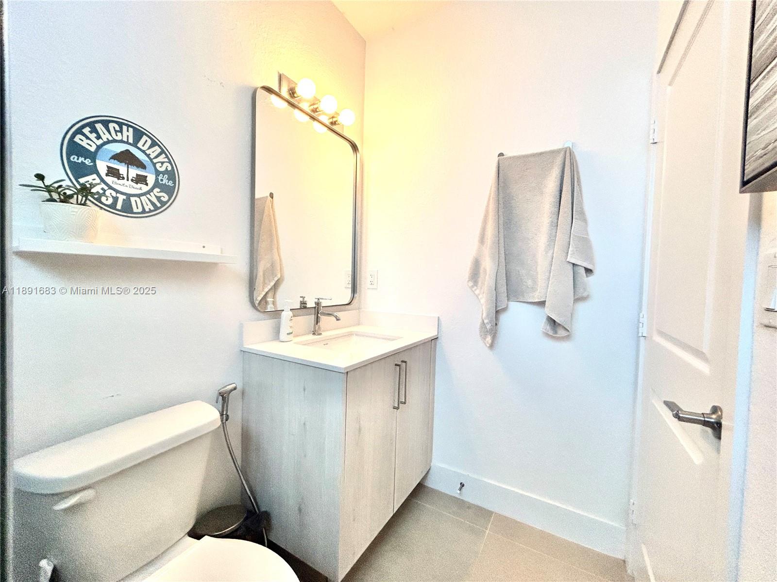 13281 Southwest 227th Street, Unit 1 Miami, FL 33170 - Photo 8 of 8 a bathroom with a toilet sink and mirror