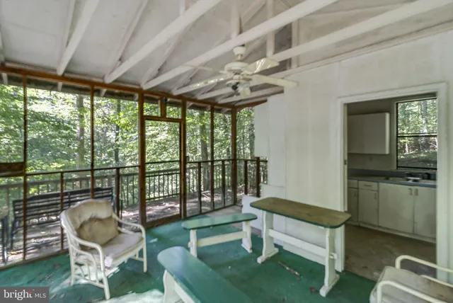 a view of a hallway with wooden floor and entryway