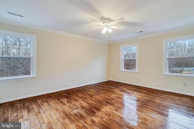 an aerial view of a house with a yard and swimming pool