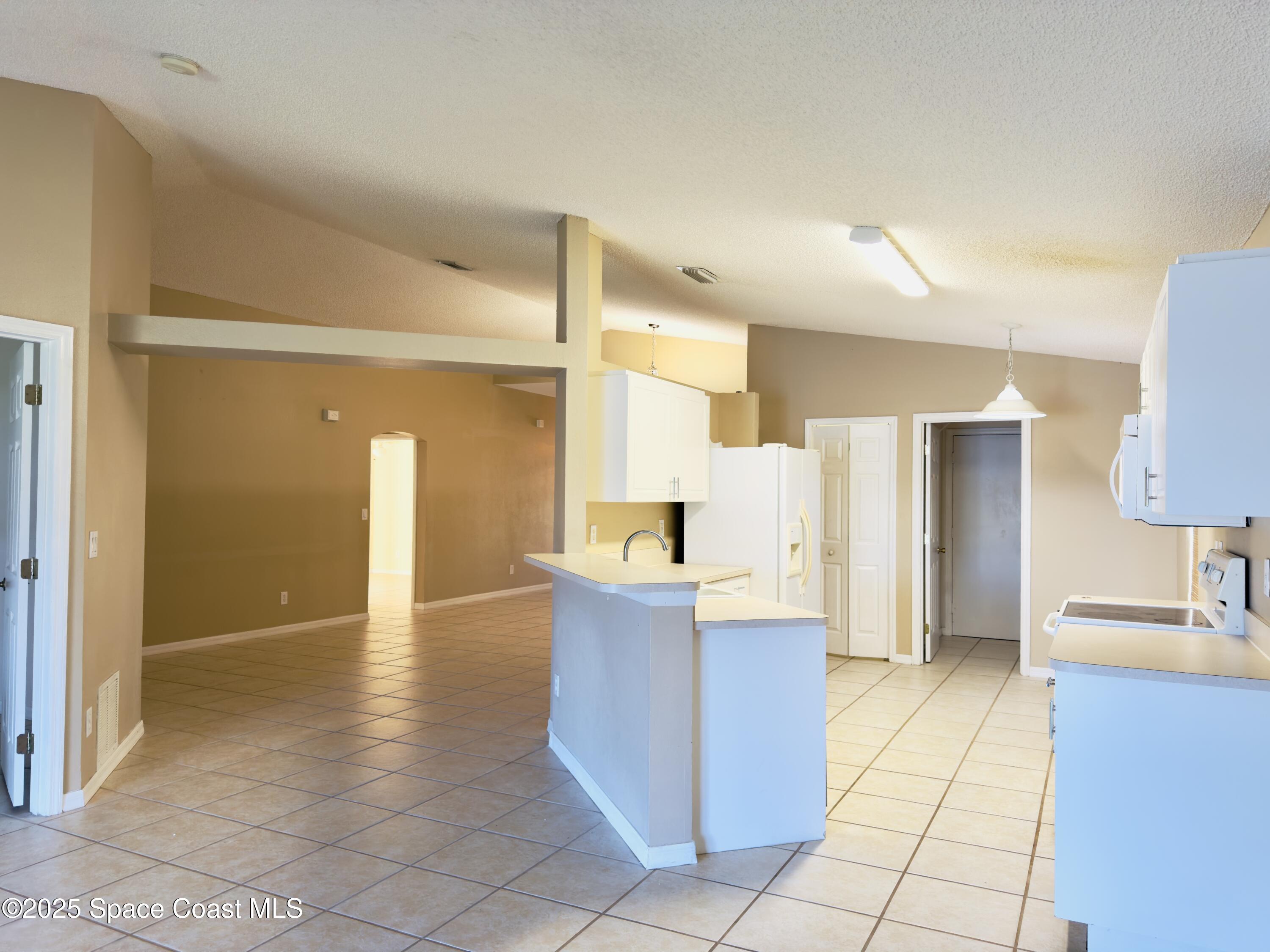 4691 Manchester Drive Rockledge, FL 32955 - Photo 3 of 6 a view of a kitchen cabinets and a counter place