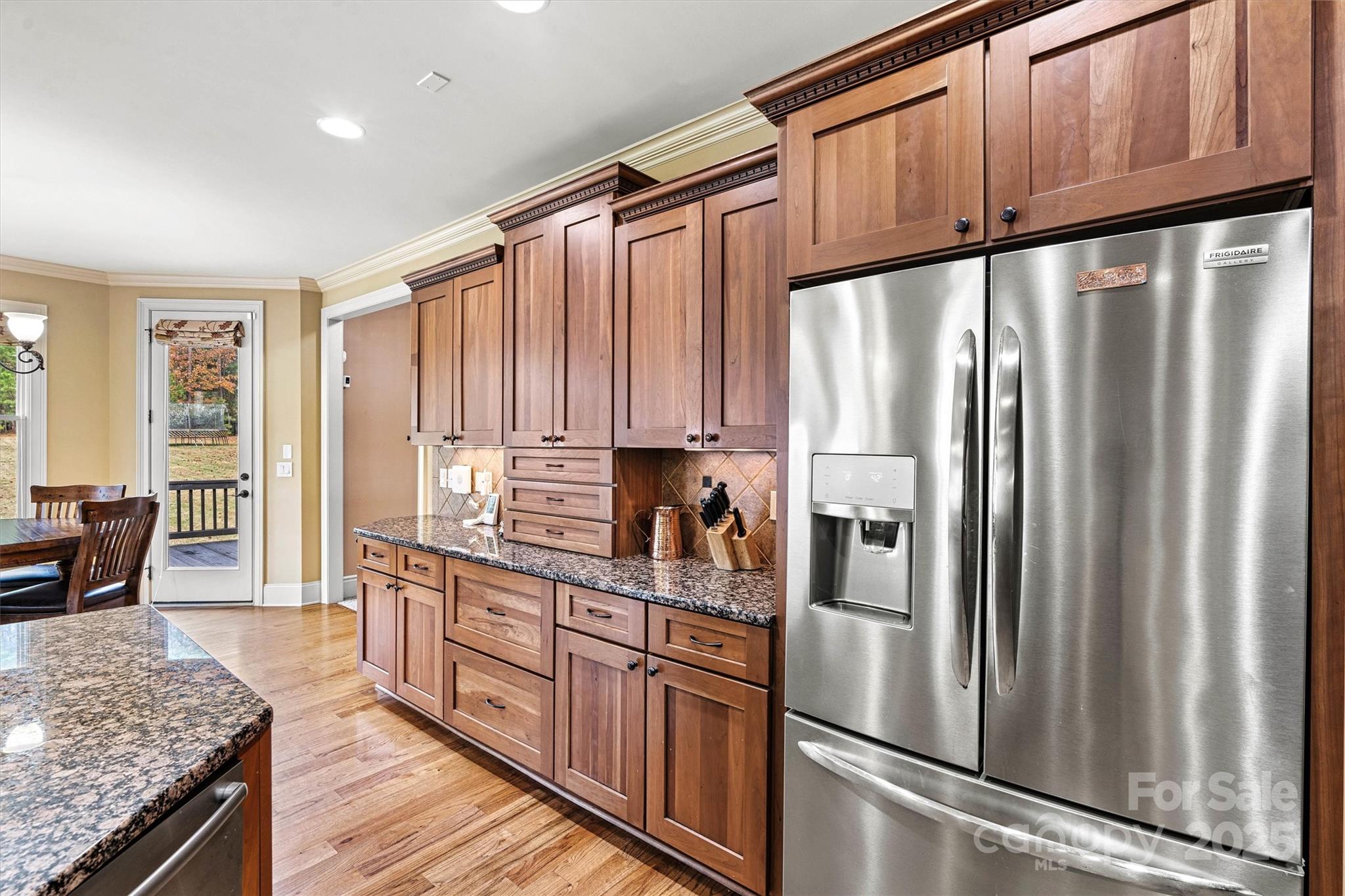 336 Kenway Loop Mooresville, NC 28117 - Photo 15 of 45 a kitchen with stainless steel appliances granite countertop a refrigerator a sink dishwasher a stove and white countertops with wooden floor