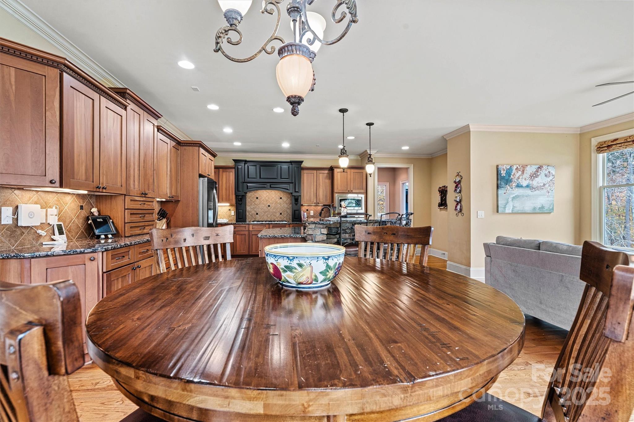 336 Kenway Loop Mooresville, NC 28117 - Photo 20 of 45 a dining room with wooden floor and large windows