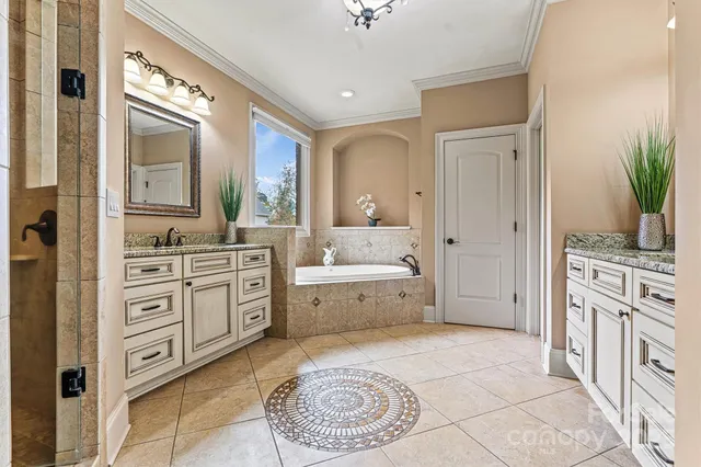 a spacious bathroom with a granite countertop sink a mirror a bathtub and a window