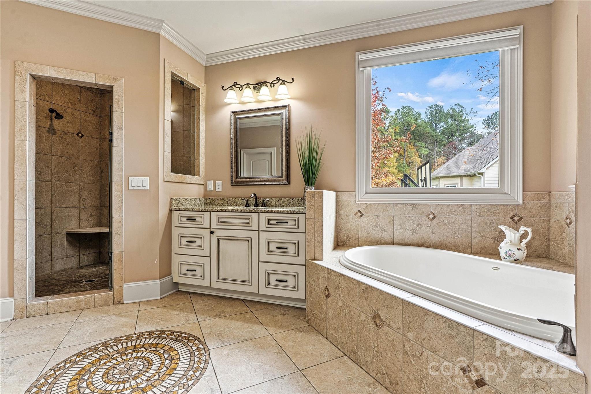336 Kenway Loop Mooresville, NC 28117 - Photo 27 of 45 a spacious bathroom with a tub a sink and a window