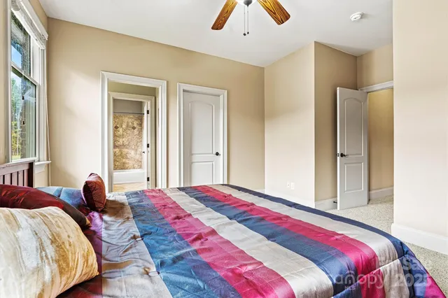 a bedroom with two beds and a chandelier
