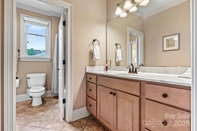 a bathroom with a sink a toilet and a mirror