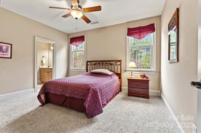 a spacious bedroom with a bed and a chandelier
