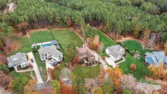 an aerial view of a house with a yard and outdoor seating