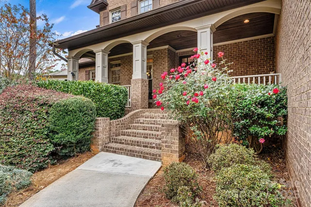 a front view of a house with a yard and fountain