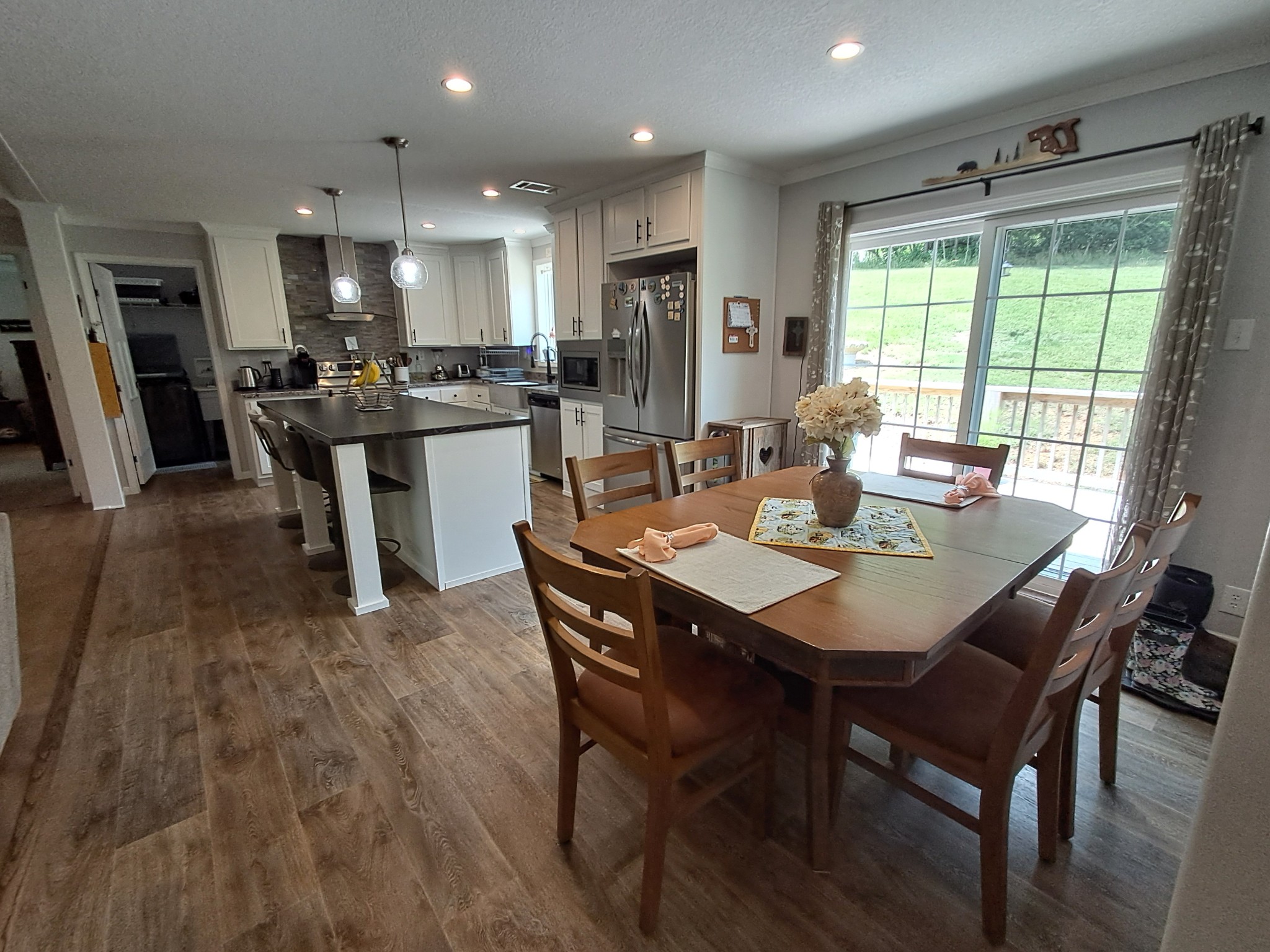 5525 Wiley Hollow Road Culleoka, TN 38451 - Photo 36 of 64 a dining room with stainless steel appliances kitchen island granite countertop furniture and wooden floor