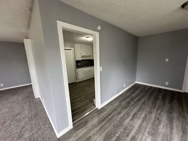 wooden floor in a hall with an empty room