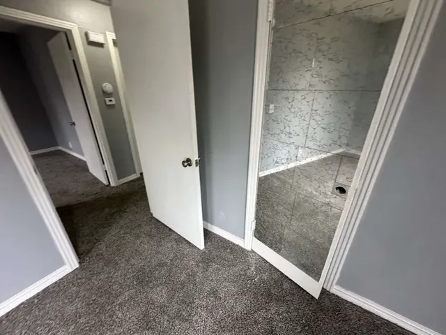 an empty room with windows and closet
