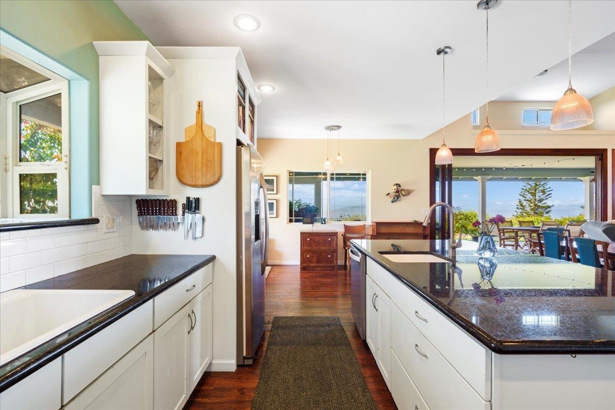40 Pulehu Road Kula, HI 96790 - Photo 11 of 49 a kitchen with stainless steel appliances granite countertop a sink a stove and a wooden floors