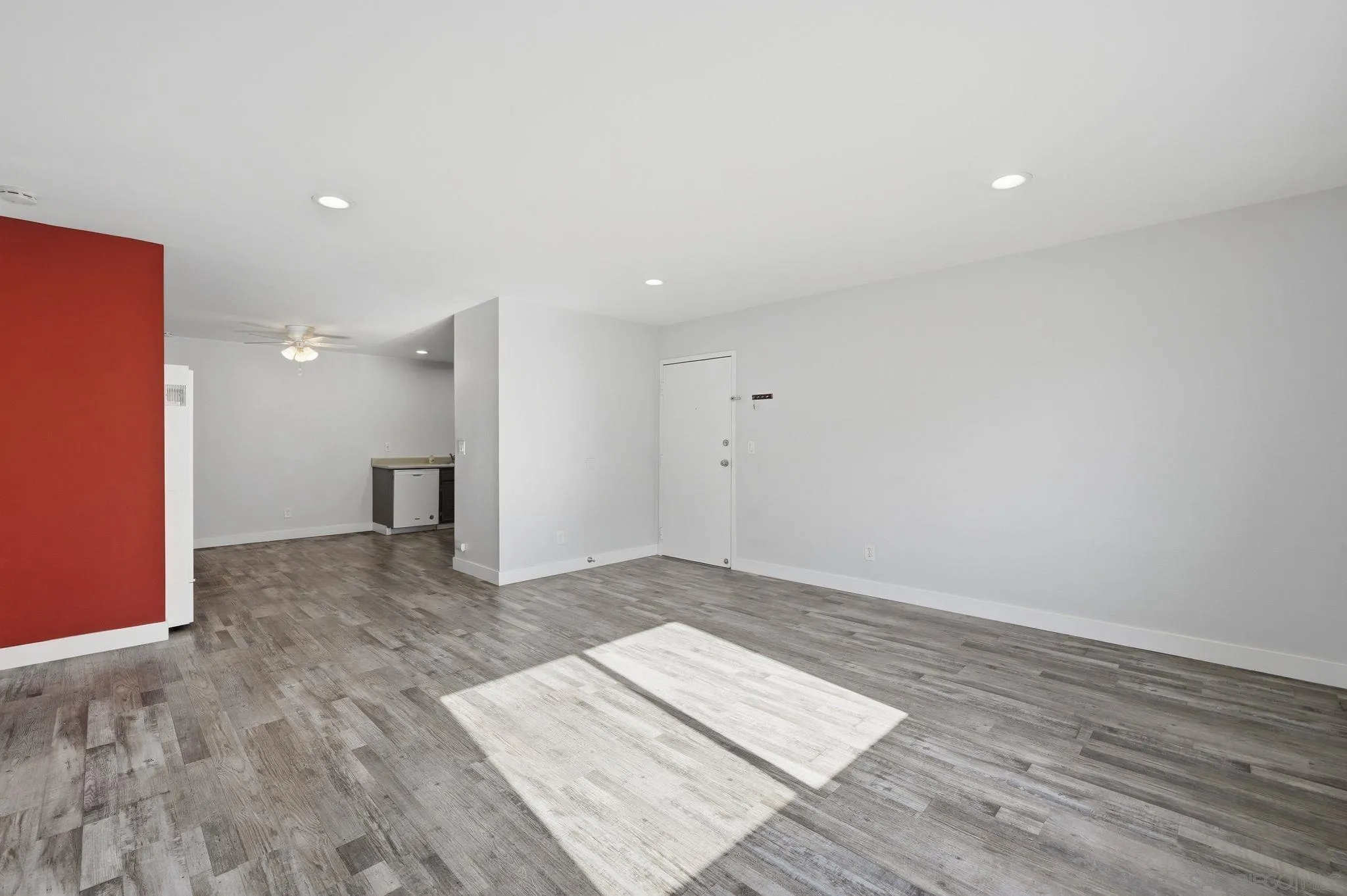 293 Sycamore Road, Unit 15 San Ysidro, CA 92173 - Photo 2 of 25 a view of an empty room with wooden floor and a window