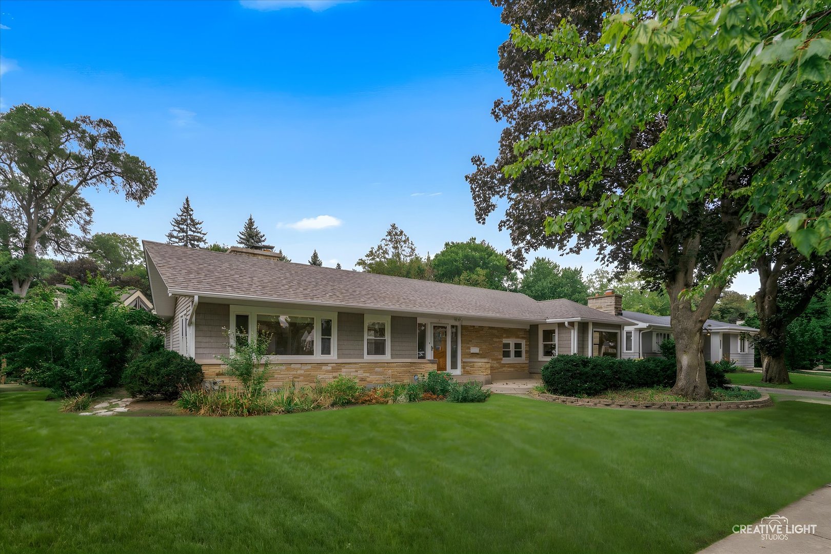 a front view of a house with a garden
