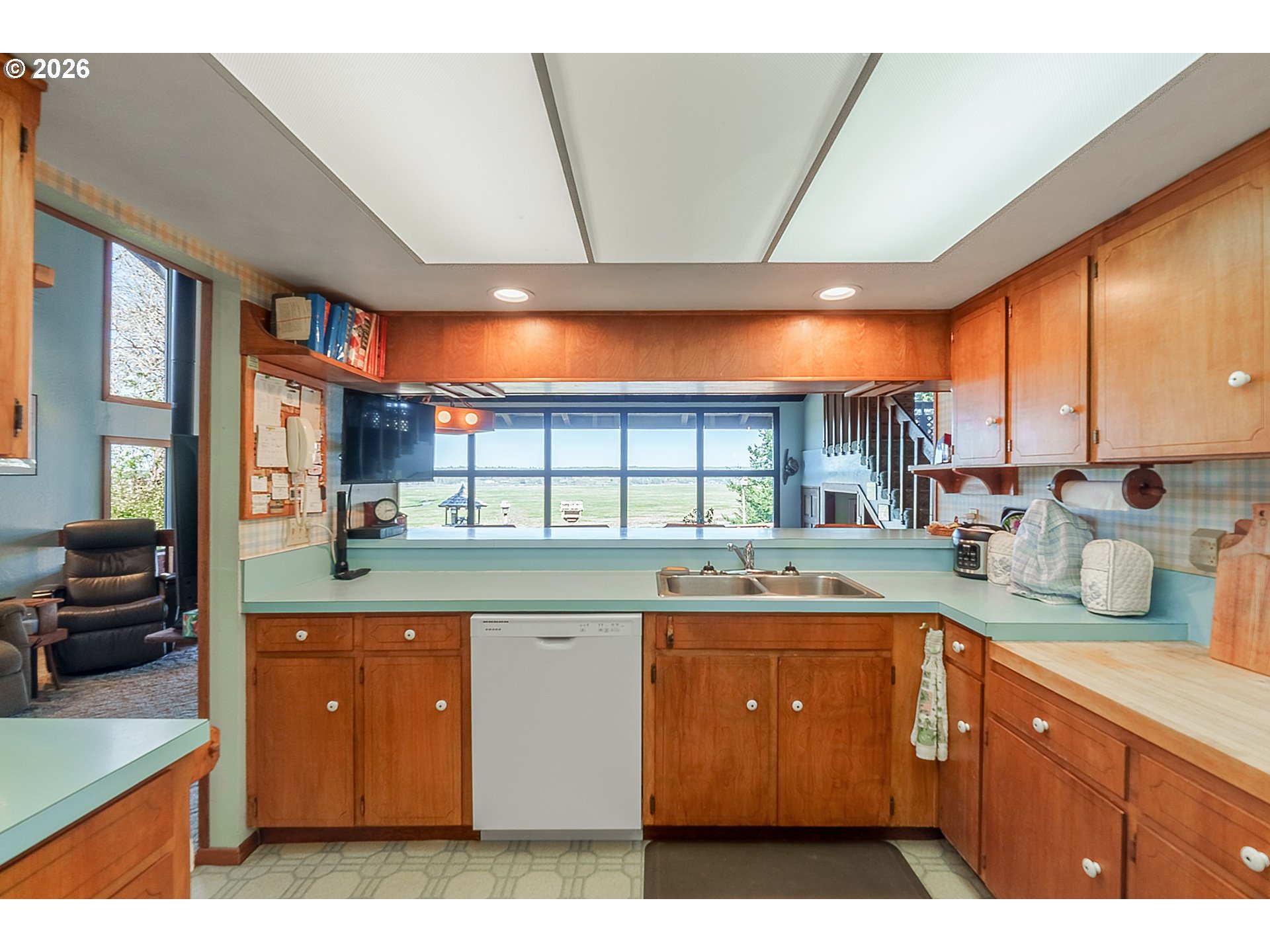 56358 Rusty Road Bandon, OR 97411 - Photo 16 of 41 a kitchen with stainless steel appliances kitchen island granite countertop a sink and cabinets