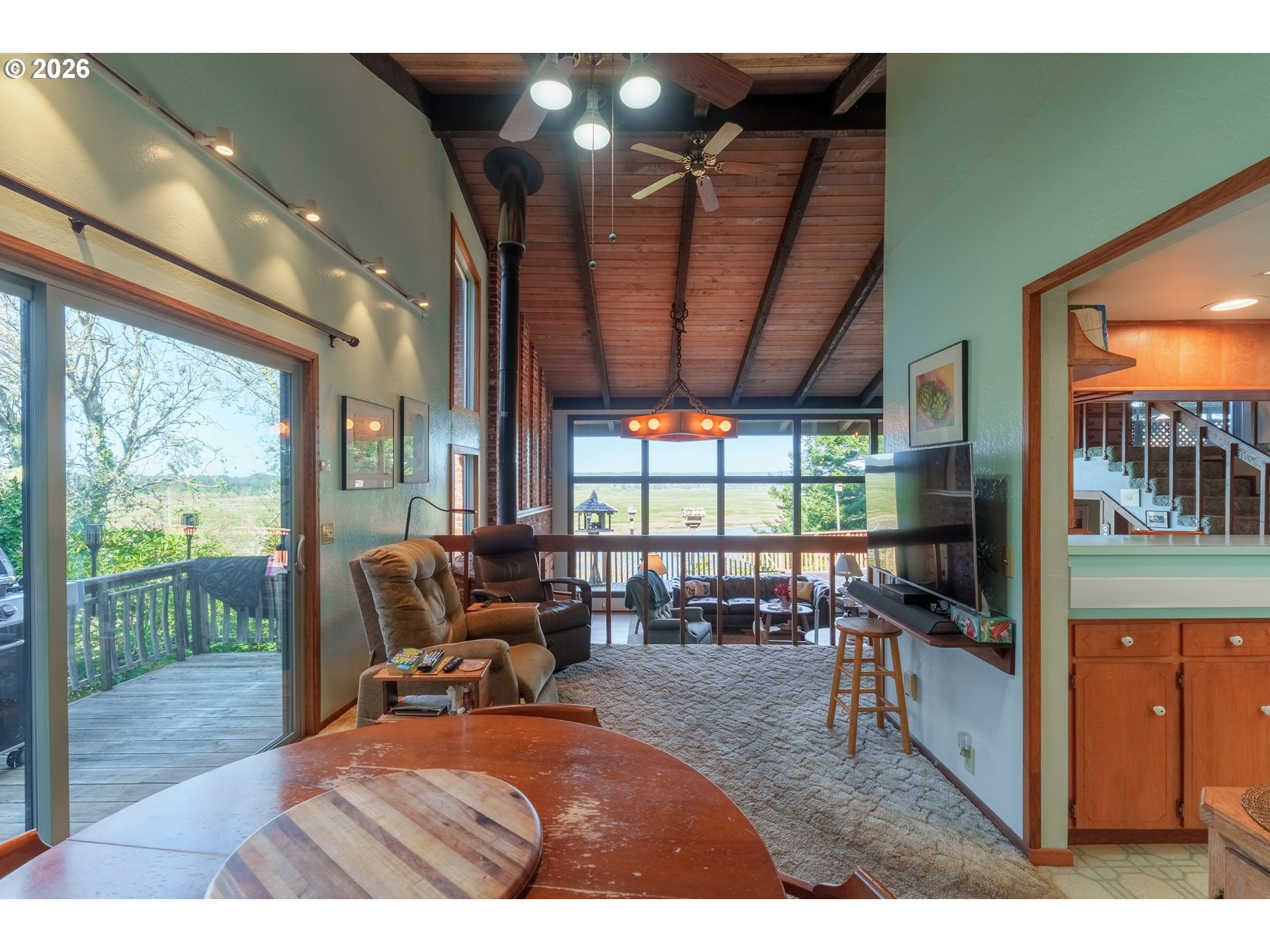 56358 Rusty Road Bandon, OR 97411 - Photo 19 of 41 a living room with furniture tv and large windows