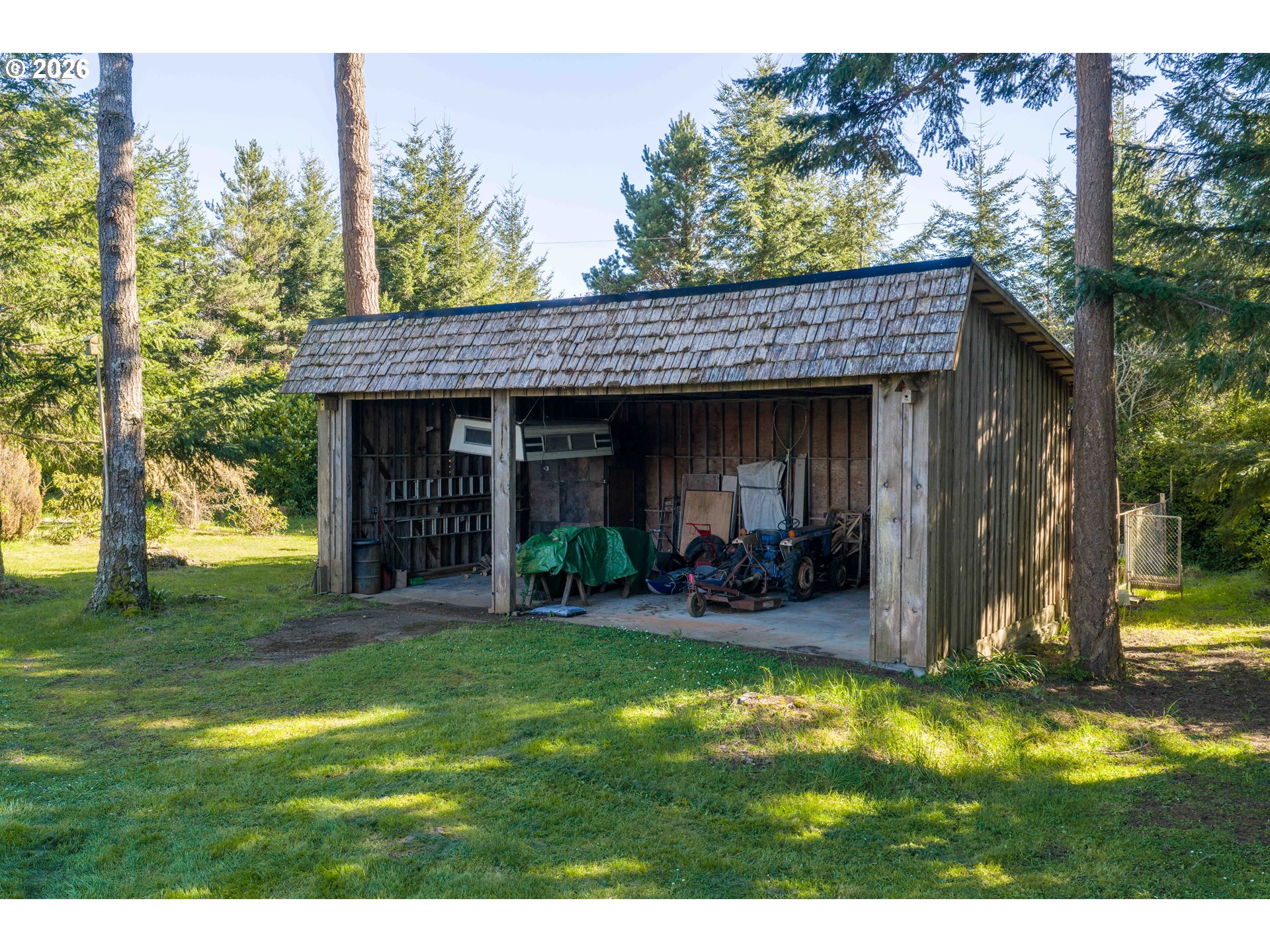 56358 Rusty Road Bandon, OR 97411 - Photo 26 of 41 a view of a house with backyard porch and sitting area