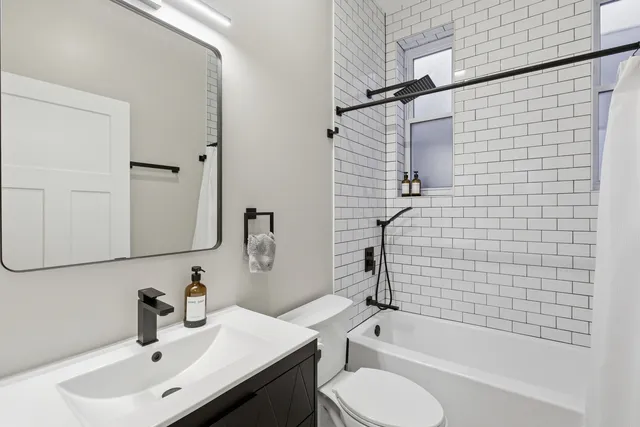 a bathroom with a sink toilet and shower