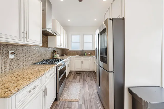 a kitchen with a sink stove and refrigerator