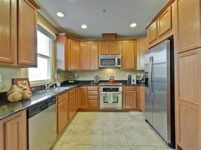 247 Peppermint Tree Terrace, Unit 3 Sunnyvale, CA 94086 - Photo 8 of 25 a kitchen with a refrigerator sink and cabinets