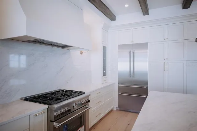 a kitchen with cabinets and stainless steel appliances